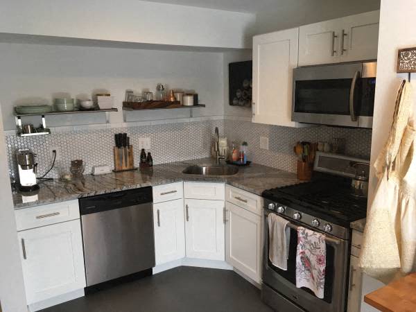 a kitchen with stainless steel appliances and white cabinets